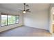Spacious bedroom with carpet, large window and ceiling fan at 6608 W Whispering Wind Dr, Glendale, AZ 85310