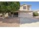 Traditional two-story home featuring a two-car garage and desert landscaping in a residential community at 6608 W Whispering Wind Dr, Glendale, AZ 85310