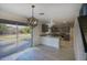 Eat-in kitchen featuring modern light fixtures, stainless steel appliances, and sliding glass door to patio at 6608 W Whispering Wind Dr, Glendale, AZ 85310