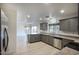 Bright kitchen featuring stainless steel appliances, gray cabinets, and eat in dining area at 6608 W Whispering Wind Dr, Glendale, AZ 85310