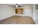 Open living room with hard surface floors, large window, and neutral wall colors at 6608 W Whispering Wind Dr, Glendale, AZ 85310