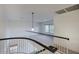 Upstairs loft area features wood railing and overlooks the living room and foyer at 6608 W Whispering Wind Dr, Glendale, AZ 85310