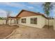 This backyard has a patio, fresh paint, mature trees, and low-maintenance desert landscaping at 7056 W Caron Dr, Peoria, AZ 85345
