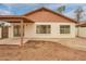 Rear exterior view of the home features a covered patio and spacious backyard at 7056 W Caron Dr, Peoria, AZ 85345