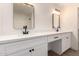 Bright bathroom featuring dual sinks, modern fixtures, vanity space, and white marble shower at 7056 W Caron Dr, Peoria, AZ 85345