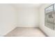 Bright bedroom features neutral carpet, fresh white paint, and a large window for plenty of natural light at 7056 W Caron Dr, Peoria, AZ 85345