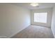 Cozy bedroom featuring neutral carpet, a window with blinds, and clean, bright walls at 7056 W Caron Dr, Peoria, AZ 85345