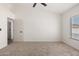 An inviting bedroom featuring a ceiling fan, new carpet and freshly painted walls at 7056 W Caron Dr, Peoria, AZ 85345
