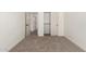A light and airy bedroom featuring a closet and new neutral carpeting at 7056 W Caron Dr, Peoria, AZ 85345