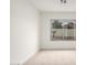 A sunlit bedroom boasts neutral carpet and a large window overlooking the outdoors at 7056 W Caron Dr, Peoria, AZ 85345