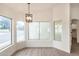 Bright dining area with large windows and a modern chandelier at 7056 W Caron Dr, Peoria, AZ 85345