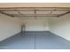 Clean and spacious garage interior with painted floor and ample storage space at 7056 W Caron Dr, Peoria, AZ 85345