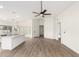 Open floor plan with a kitchen island, ceiling fan and laminate wood flooring at 7056 W Caron Dr, Peoria, AZ 85345