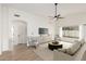 Bright living room with modern furnishings, fan, light wood floors, and natural light from a large window at 7056 W Caron Dr, Peoria, AZ 85345