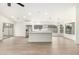 Open floor plan with an island, ceiling fan and laminate wood flooring at 7056 W Caron Dr, Peoria, AZ 85345