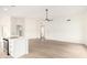 Spacious open floor plan featuring laminate wood flooring, kitchen island, and recessed lighting at 7056 W Caron Dr, Peoria, AZ 85345