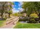 Charming wooden bridge leading to a community park with lush landscaping and serene pond at 7223 N 14Th St, Phoenix, AZ 85020