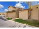 Two-story home featuring tan stucco, a two-car garage, and a well-manicured front yard at 7223 N 14Th St, Phoenix, AZ 85020