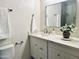 Bathroom with white cabinets, marble counters, and a large mirror at 7232 N Via Camello Del Norte -- # 3, Scottsdale, AZ 85258