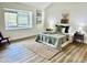 Bright bedroom featuring wood floors, a large window, and neutral decor at 7232 N Via Camello Del Norte -- # 3, Scottsdale, AZ 85258