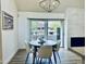 Dining area features contemporary table and chairs with natural light from sliding glass doors at 7232 N Via Camello Del Norte -- # 3, Scottsdale, AZ 85258