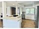 Bright kitchen features white cabinets, stainless steel appliances, and a large island with quartz countertops at 7232 N Via Camello Del Norte -- # 3, Scottsdale, AZ 85258