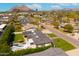 Aerial view of property in a lush neighborhood, showcasing a backyard pool and stunning mountain views at 7417 E Bonita Dr, Scottsdale, AZ 85250