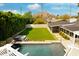Aerial shot of a private backyard featuring a pool, spa, pergola, and ample green space in a serene setting at 7417 E Bonita Dr, Scottsdale, AZ 85250