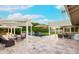 Spacious backyard patio with pool, seating, pergola, umbrellas, and lush greenery, ideal for outdoor gatherings at 7417 E Bonita Dr, Scottsdale, AZ 85250