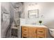 Stylish bathroom featuring vanity with wood drawers and cabinets and a marble shower at 7417 E Bonita Dr, Scottsdale, AZ 85250