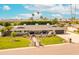 Expansive single-story home with stone accents, a manicured lawn, and mature palm trees, promising an inviting curb appeal at 7417 E Bonita Dr, Scottsdale, AZ 85250