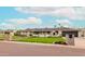 Charming single-story home featuring a well-manicured lawn, stone accents, and a private driveway at 7417 E Bonita Dr, Scottsdale, AZ 85250