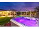 Relax in a gorgeous backyard complete with a pool, hot tub, covered seating, and lush landscaping at 7417 E Bonita Dr, Scottsdale, AZ 85250