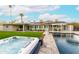Backyard hot tub with pool and grassy area offering a relaxing and enjoyable outdoor space at 7417 E Bonita Dr, Scottsdale, AZ 85250