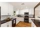 Modern kitchen with white cabinets, stainless steel appliances, and a farmhouse sink at 7417 E Bonita Dr, Scottsdale, AZ 85250