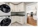 Well-organized laundry room with gray countertops, white cabinets, and modern Samsung washer and dryer at 7417 E Bonita Dr, Scottsdale, AZ 85250