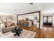 Spacious living space featuring wood floors, kitchen bar seating, and views into the kitchen at 7417 E Bonita Dr, Scottsdale, AZ 85250