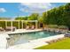 Inviting backyard pool area featuring a sparkling pool, water feature, pergola, lush landscaping, and comfortable seating at 7417 E Bonita Dr, Scottsdale, AZ 85250