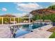 Backyard pool and patio area featuring umbrellas, seating, and a lush garden for outdoor enjoyment at 7417 E Bonita Dr, Scottsdale, AZ 85250