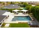 Aerial shot of a backyard pool area with lush landscaping, a hot tub, pergolas, and comfortable outdoor seating at 7417 E Bonita Dr, Scottsdale, AZ 85250