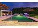 An inviting backyard showcases a sparkling pool, hot tub, lounge furniture, and manicured landscaping at 7417 E Bonita Dr, Scottsdale, AZ 85250