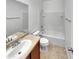 Bright bathroom featuring a large mirror, vanity with sink, toilet, and a shower-tub combination at 7720 W Pipestone Pl, Phoenix, AZ 85035