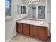 Bathroom featuring dual sinks, modern fixtures, and a large mirror at 7720 W Pipestone Pl, Phoenix, AZ 85035