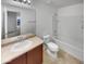Clean bathroom with double vanity, a large mirror, and tub/shower combo at 7720 W Pipestone Pl, Phoenix, AZ 85035