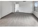 Expansive bedroom with neutral carpet, white walls and lots of natural light from surrounding windows at 7720 W Pipestone Pl, Phoenix, AZ 85035