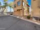 A back view of the townhome with a garage at 7720 W Pipestone Pl, Phoenix, AZ 85035