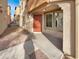 Inviting front entrance with a vibrant orange door and well-maintained landscaping at 7720 W Pipestone Pl, Phoenix, AZ 85035