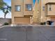 Back exterior showcasing the garage and landscaping at 7720 W Pipestone Pl, Phoenix, AZ 85035
