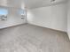 Open living room featuring lots of natural light, neutral carpet and walls at 7720 W Pipestone Pl, Phoenix, AZ 85035