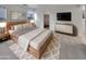 Comfortable main bedroom showcasing a wooden bed frame, soft colors, and modern accents at 7720 W Pipestone Pl, Phoenix, AZ 85035